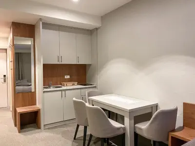 a kitchen with a white table and chairs at Kopaonik Centar Konaci in Kopaonik