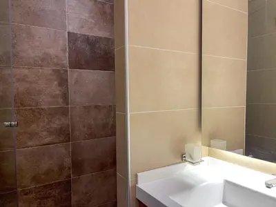 a bathroom with a sink and a mirror at Kopaonik Centar Konaci in Kopaonik