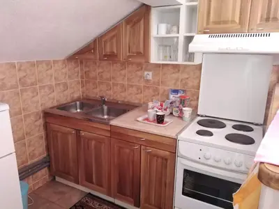 a kitchen with a sink and a stove top oven at Apartmani Odmor i Mir in Vranje