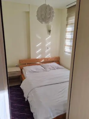 a bedroom with a white bed and a window at Villa Zvončica, Apartman ViN in Kopaonik