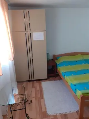 a room with a bed and a refrigerator at Smestaj Stankovic in Soko Banja