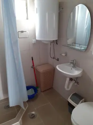 a bathroom with a sink and a toilet and a mirror at Smestaj Stankovic in Soko Banja