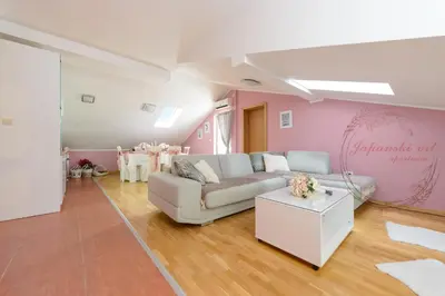 a living room with a couch and a table at Apartman Japanski vrt, Centar in Vrnjačka Banja