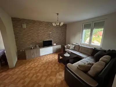 a living room with a couch and a tv at Seosko domacinstvo Vujic Sokobanja Resnik in Resnik