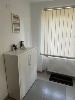 a room with a white cabinet and a radiator at Seosko domacinstvo Vujic Sokobanja Resnik in Resnik
