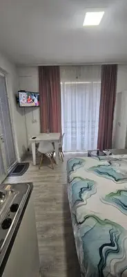 a room with a bed and a table in it at Apartman Casa Lux in Vrnjačka Banja
