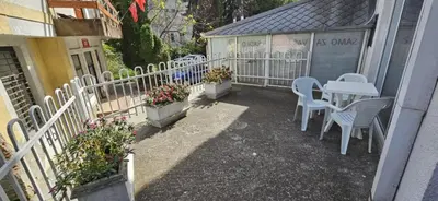 a patio with a table and chairs and a fence at Apartman Casa Lux in Vrnjačka Banja