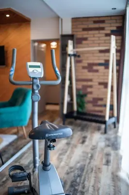 a gym with a exercise bike in a room at City apartment and gym in Niš