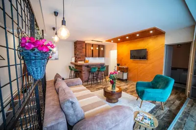 a living room with a couch and a table at City apartment and gym in Niš