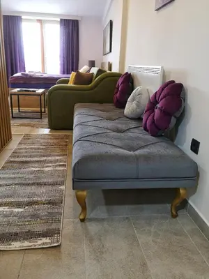 a living room with a couch and pillows at Mips P86 Milmari Resort in Kopaonik