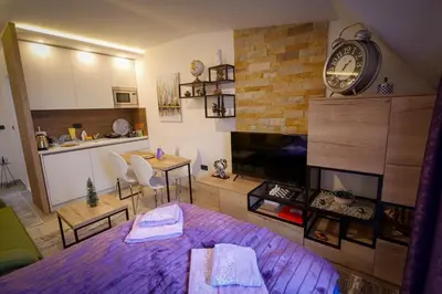 a living room with a large clock on the wall at Mips P86 Milmari Resort in Kopaonik