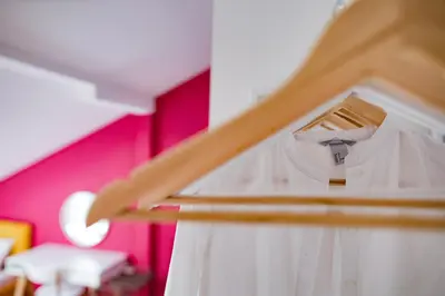 a white shirt is on a shelf in a room at Different Apartments in Niš