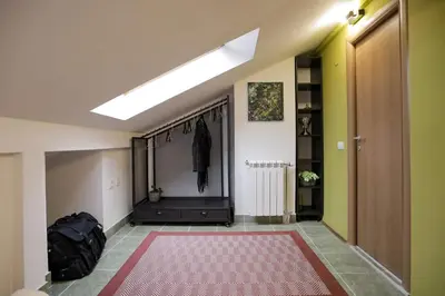 a hallway with a red rug on the floor at Different Apartments in Niš