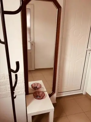 two donuts sitting on a table in front of a mirror at Apartman Banjica 1 in Soko Banja