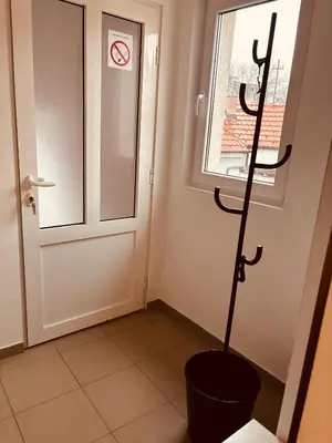 a room with a toilet in front of a door at Apartman Banjica 1 in Soko Banja
