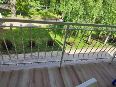 a railing on a balcony with a view of a yard at Apartman Banjica 1 in Soko Banja