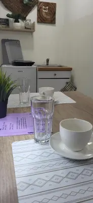 a wooden table with plates and bowls on it at Studio Milica in Vrnjačka Banja