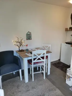 a table and chairs in a room with a table and a chair at Studio Milica in Vrnjačka Banja