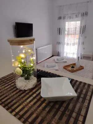 a fish tank with flowers in it on a table at Apartmani Ruj in Soko Banja