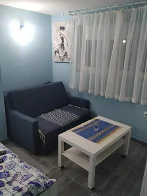 a living room with a couch and a coffee table at Apartman Azzuro Vrnjačka Banja in Vrnjačka Banja
