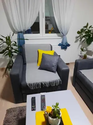a living room with a couch and a table at Sunce in Kruševac