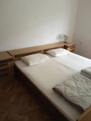 a bed with two pillows on it in a room at Domaćinstvo Trifunović in Pretrešnja