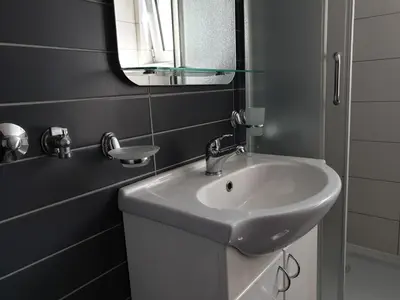 a bathroom with a white sink and a mirror at Happy in Vrnjačka Banja