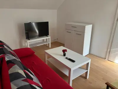a living room with a red couch and a white coffee table at Banjica 2 in Soko Banja
