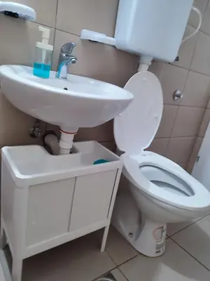 a bathroom with a white toilet and a sink at Banjica 2 in Soko Banja