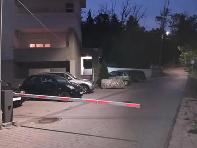 two cars parked in a parking lot next to a building at Apartman Radmanovac 2 in Vrnjačka Banja
