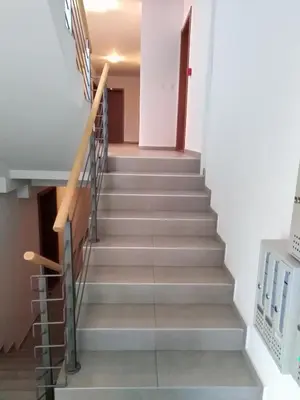 a staircase in a house with a stair case at Apartman Radmanovac 2 in Vrnjačka Banja