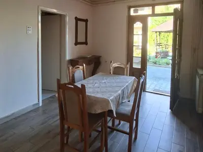 a dining room with a table and chairs and a window at Apartmani Arsic in Vrnjačka Banja