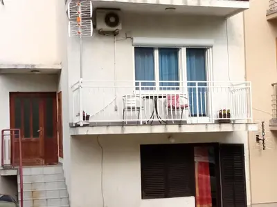 a building with a balcony with chairs on it at Studio Koral in Soko Banja