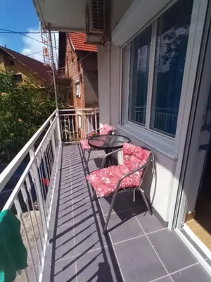 a patio with two chairs and a table on a balcony at Studio Koral in Soko Banja