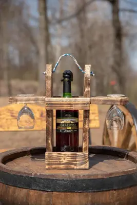 a bottle of alcohol in a wooden holder on a barrel at KONAK LJUBICA Rtanj in Boljevac