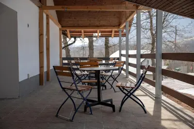 a patio with a table and chairs on a porch at KONAK LJUBICA Rtanj in Boljevac