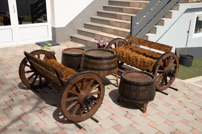 a woodenoked carriage and drums on a patio at KONAK LJUBICA Rtanj in Boljevac