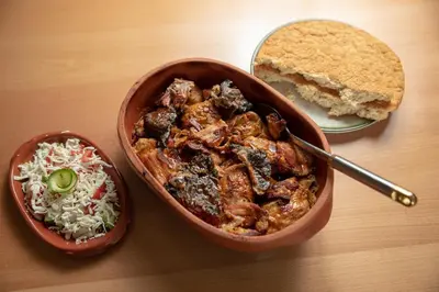 a table with a bowl of food and a plate of bread at KONAK LJUBICA Rtanj in Boljevac
