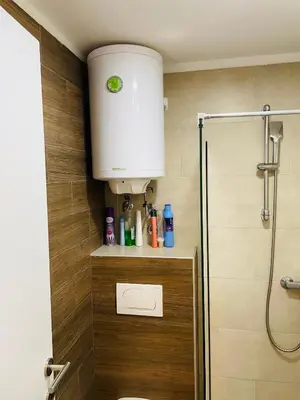 a bathroom with a shower with a toilet and a sink at AM apartments in Kopaonik
