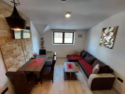 a living room with a couch and a table at AM apartments in Kopaonik