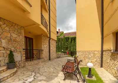 a bench sitting outside of a building at Apartman Modena Lux in Vrnjačka Banja
