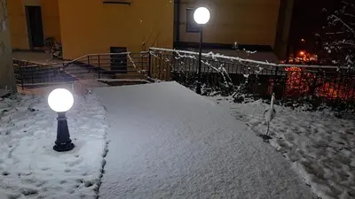 a light pole in the snow at night at Apartman Modena Lux in Vrnjačka Banja