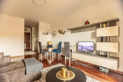 a living room with a couch and a table at Apartman Modena Lux in Vrnjačka Banja