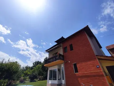 a brick building with a balcony on top of it at Konak Mali Raj in Vrnjačka Banja