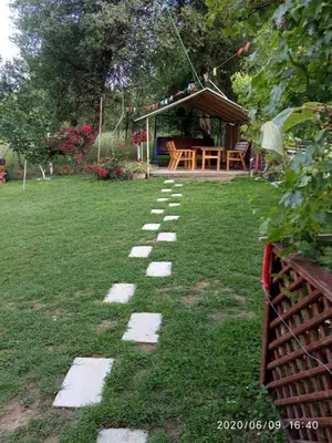 a stepping stone path in a yard with a gazebo at Konak Mali Raj in Vrnjačka Banja
