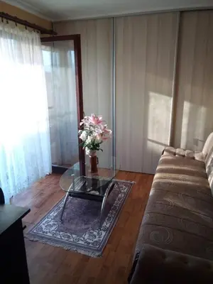 a living room with a glass table and a couch at Konak Mali Raj in Vrnjačka Banja