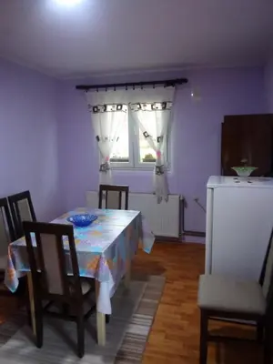 a dining room with a table and chairs and a window at Konak Mali Raj in Vrnjačka Banja
