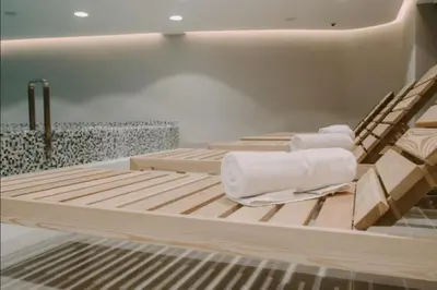 a room with two beds with towels on them at Imperia Apartments in Vrnjačka Banja