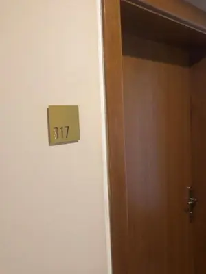 a door with a sign that says on it at Imperia Apartments in Vrnjačka Banja