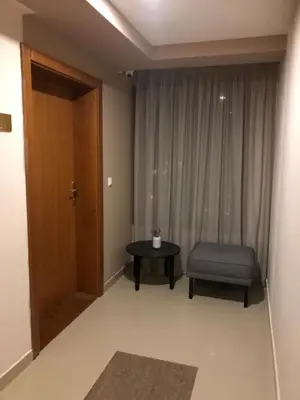 a room with a door and a chair and a table at Imperia Apartments in Vrnjačka Banja